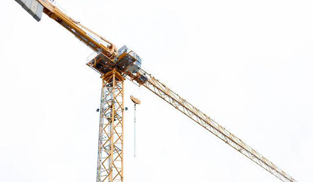 The crane is a symbol of the construction and transportation of physical objects on a large scale.